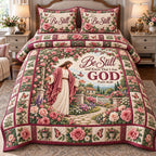 Rose Garden Gate Be Still And Know God quilted 3-piece bedding set on a made bed in a softly lit bedroom