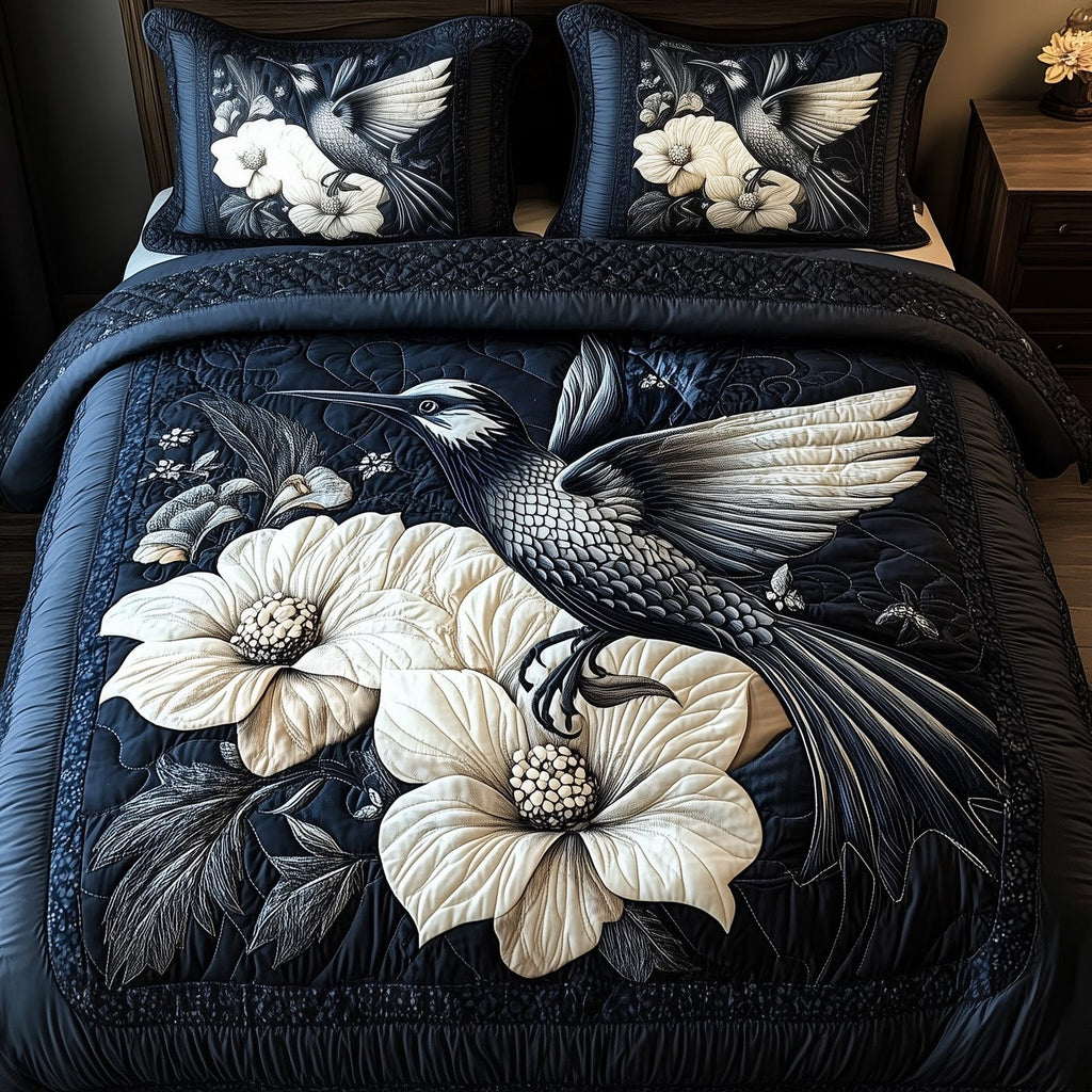 Shadowlight Hummingbird Flight quilted 3-piece bedding set on a made bed with two matching pillow shams