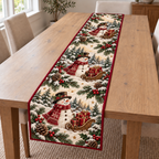 Three snowmen with gift-filled brown sleighs printed on an ivory quilted Christmas table runner with cranberry binding; design mockup.