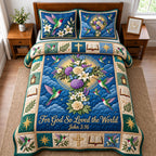 So Loved The World quilted 3-piece bedding set on a made bed with two matching pillow shams