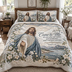 The Welcoming Savior quilted 3-piece bedding set on a made bed with two matching pillow shams